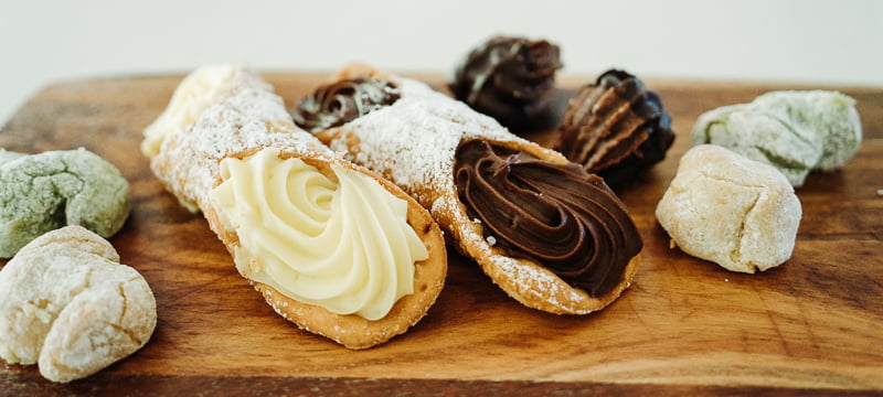 A platter with delicious cannoli and baci